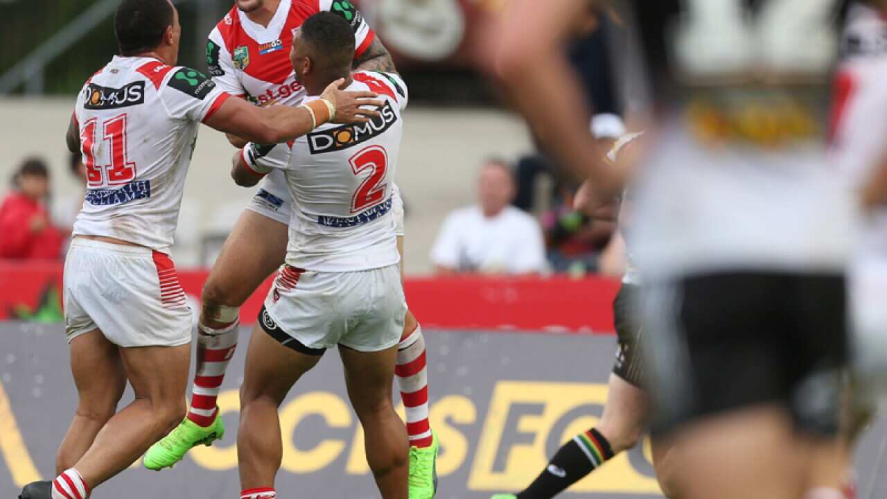 Gareth Widdopof the Dragons celebrates after scoring