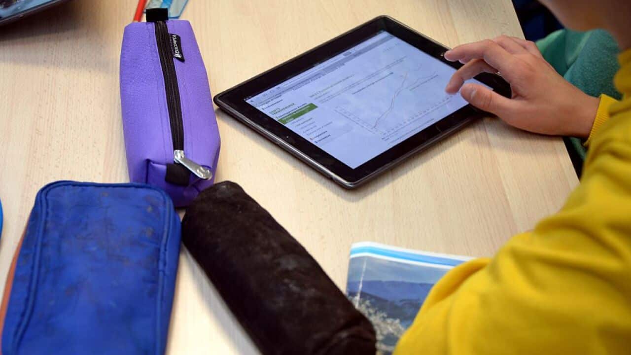 A pupil uses a tablet