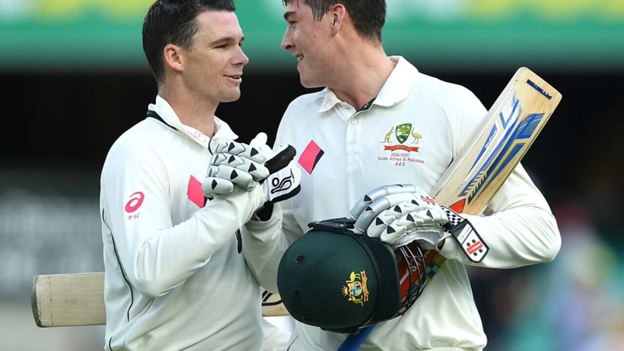 Peter Handscomb of Australia congratulates Matt Renshaw