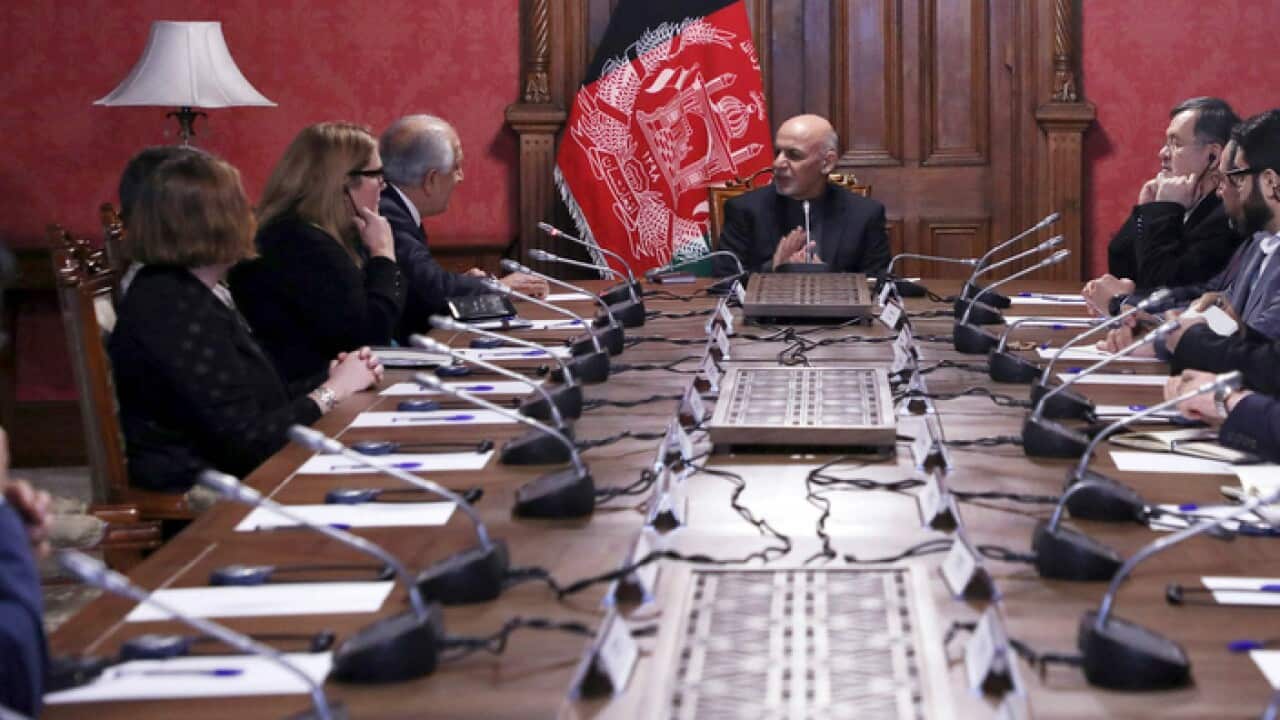 Afghan President Ashraf Ghani (c) speaks to US peace envoy Zalmay Khalilzad (3rd from left) in Kabul