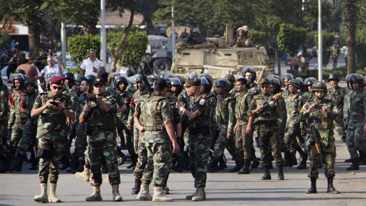 Egyptian Army soldiers block a road