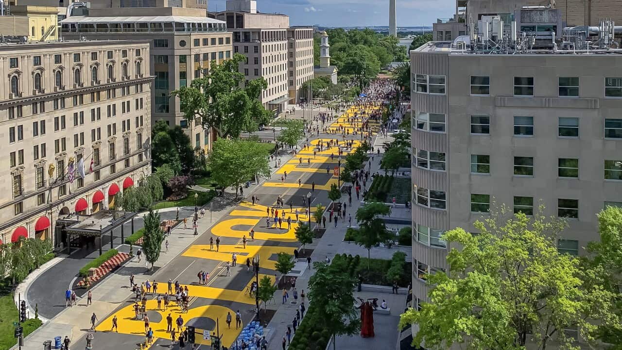 A large-scale yellow mural spelling