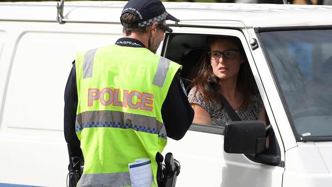 Police stop motorists crossing the Queensland-NSW border to check to for permits.