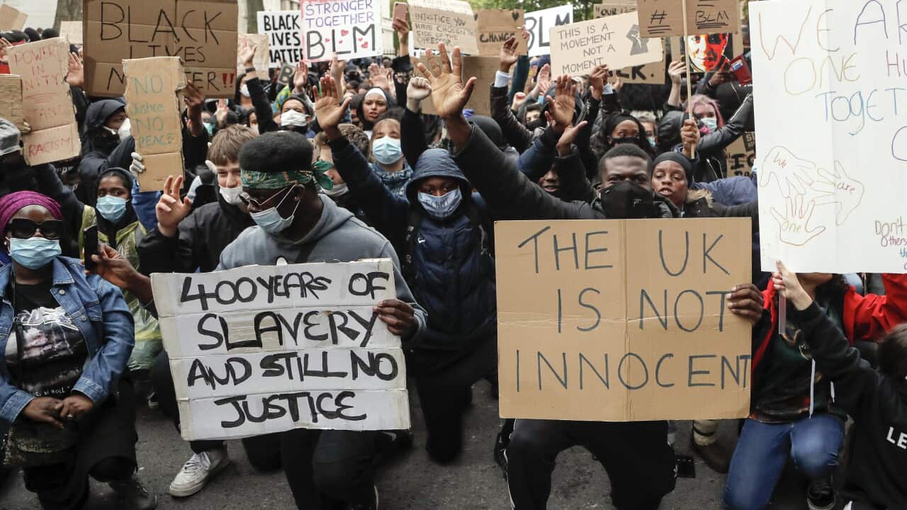 In this file photo dated Saturday, June 6, 2020, demonstrators gather outside Downing Street during a Black Lives Matter march in London