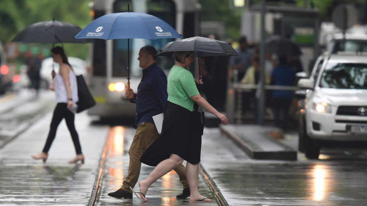 City workers in the rain in Melbourne