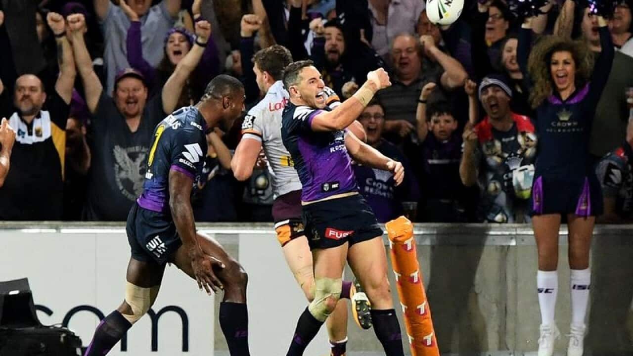 Billy Slater celebrates after scoring a try