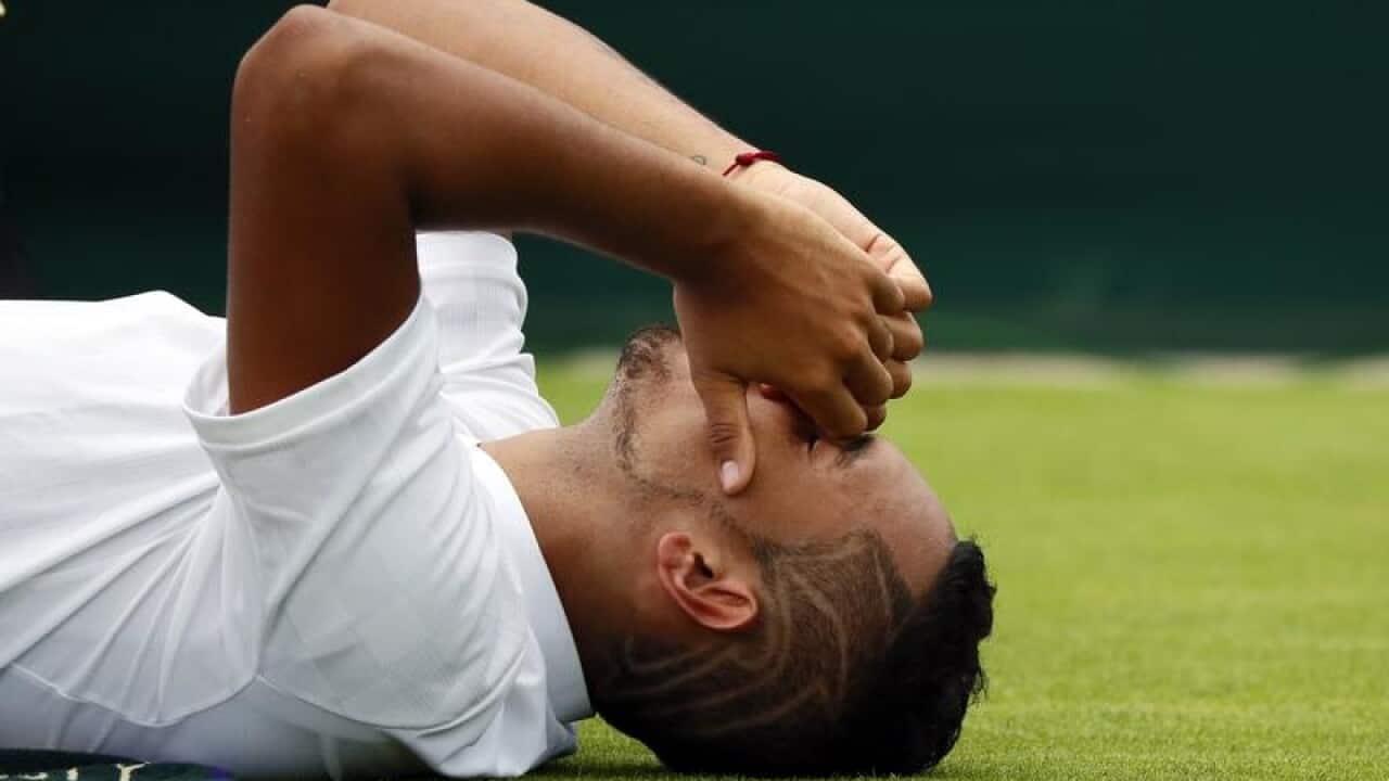 Nick Kyrgios winces in pain.