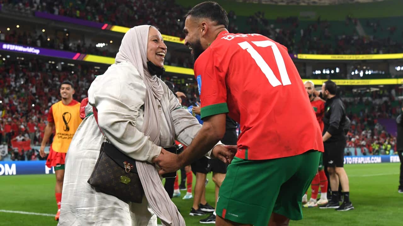 Two people dancing on a football field.