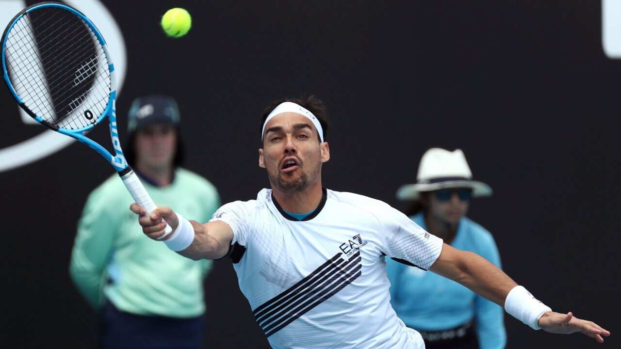 Italy's Fabio Fognini makes a forehand return to Reilly Opelka of the U.S., during their first round singles match at the Australian Open tennis championship in Melbourne, Australia, Tuesday, Jan. 21, 2020. (AP Photo/Dita Alangkara)