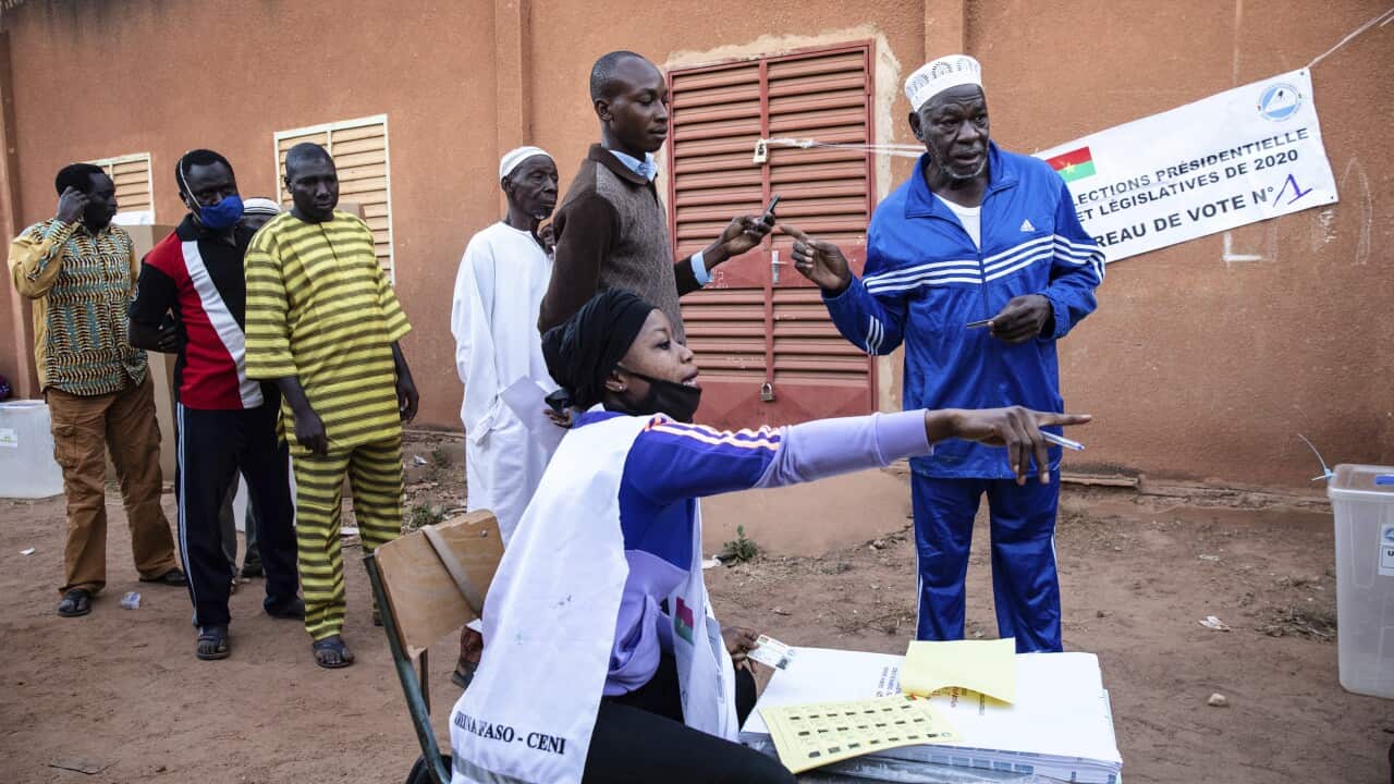 People line up to vote in Burkina Faso's presidential and legislative elections as polling stations open in Ouagadougou on 22 November, 2020.