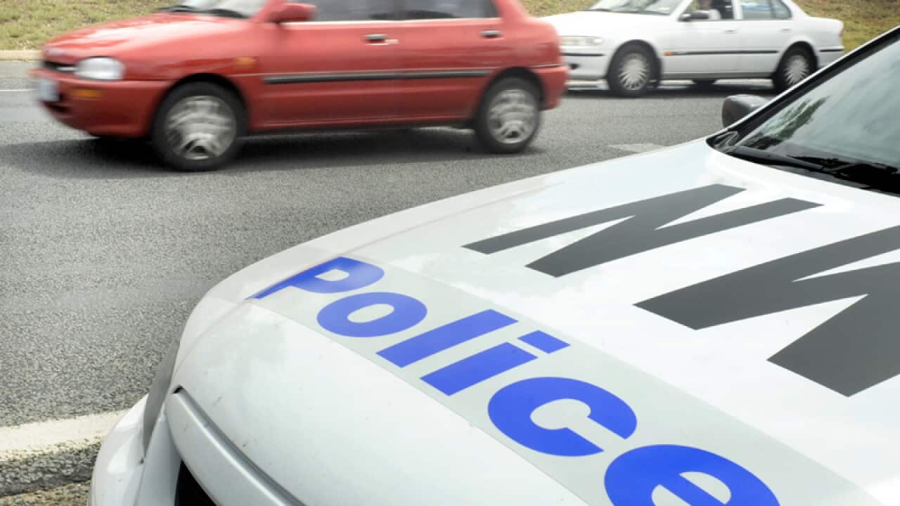 A police car monitors traffic in Canberra