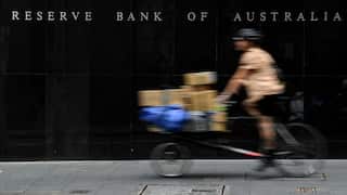 A bike moving past the Reserve Bank of Australia building.