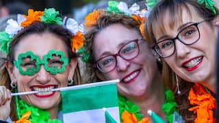 Three women with Irish tricolour headbands and glasses