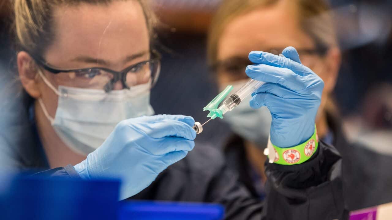 A healthcare worker prepares the COVID-19 vaccine at a mass vaccination site in Boston, Massachusetts on 29 January.
