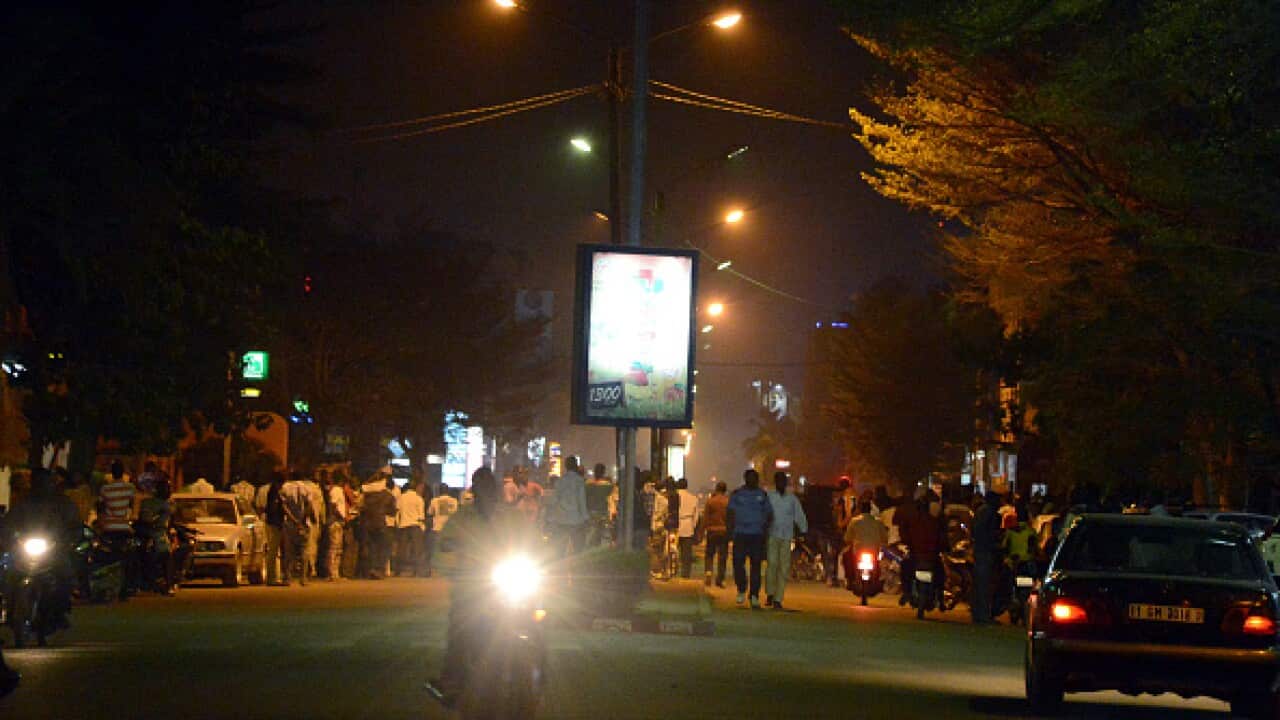 People gather on Kwame Nkruma avenue near Hotel Splendid where the attackers remain with sporadic gunfire continuing in Burkina Faso's capital Ouagadougou on January 15, 2016. (AFP/Getty)