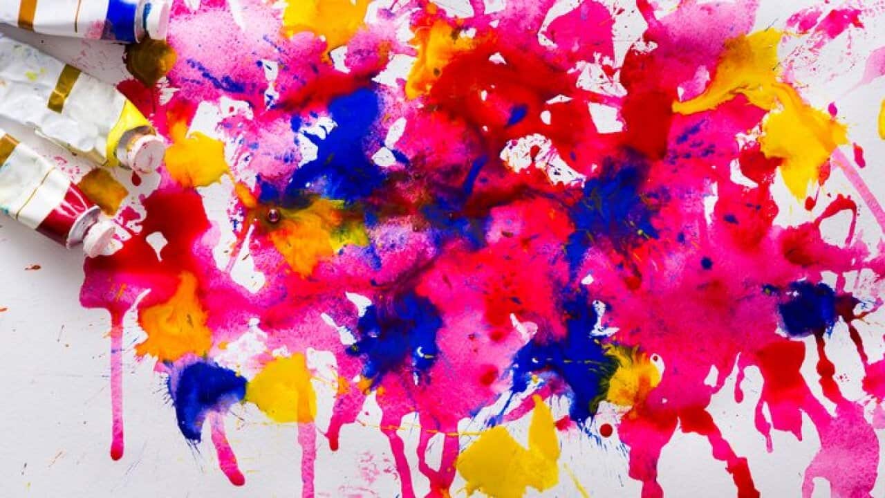 Artistic colorful background. Oil-paint tubes on watercolor drawing