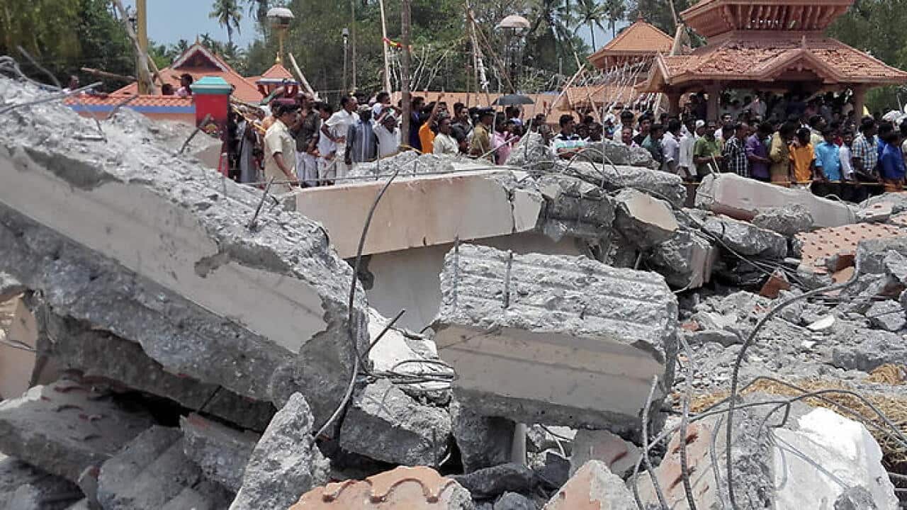 A view of a collapsed building after a massive fire broke out during a fireworks display at the Puttingal temple complex in Paravoor village
