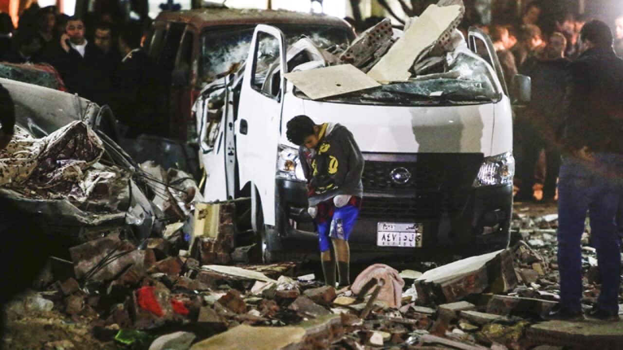 Egyptians at the scene of an explosion in Cairo