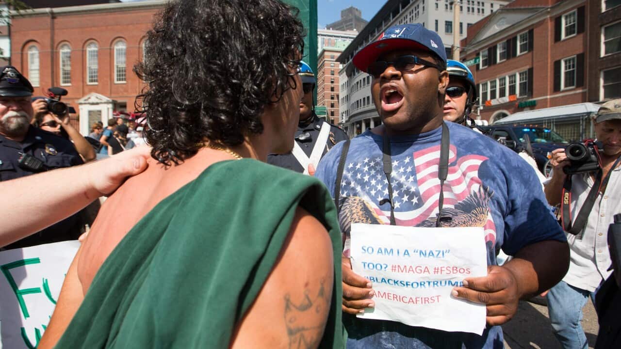A supporter of President Donald Trump argues with a counter-protester in Boston.