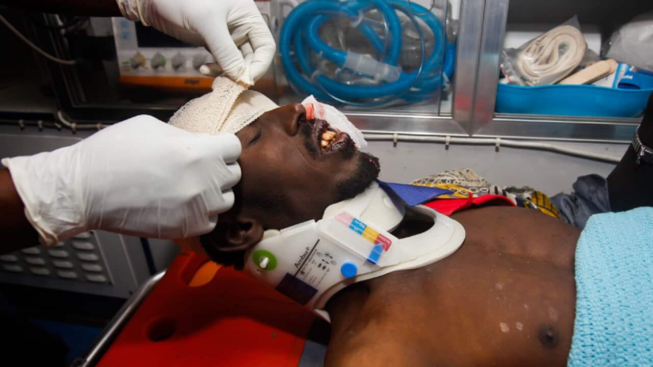 An attack survivor is attended by Kenyan Red Cross officials
