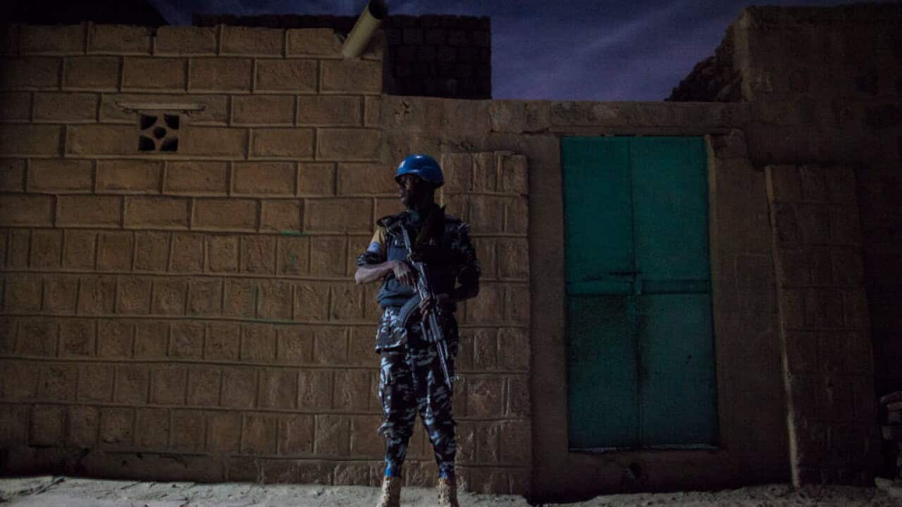 A United Nations Policeman stands on guard during a night patrol in the Abaradiou neighborhood in Timbuktu, Mali on Monday, January 9, 2017.