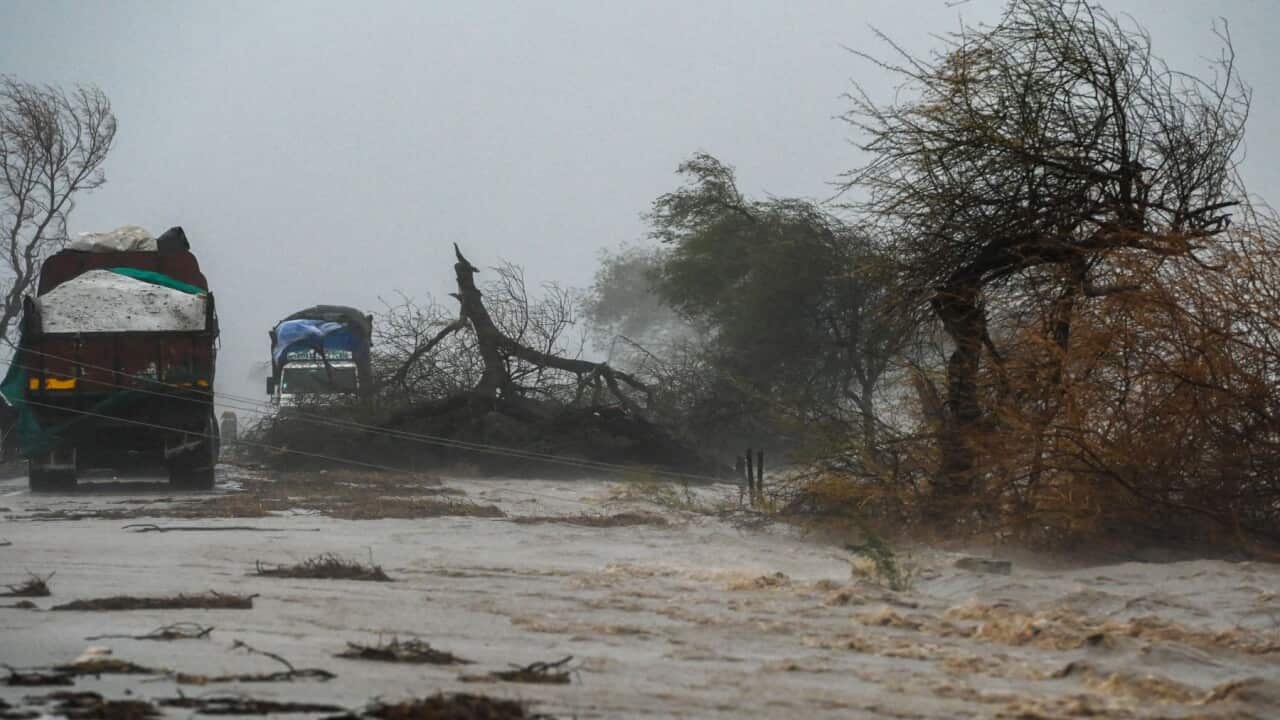 Trucks are stranded on a flooded highway near Diu on May 18, 2021, after Cyclone Tauktae blasted ashore in western India late May 17 with fierce winds and drenching rains that turned streets into rivers, disrupting the country's response to its devastatin