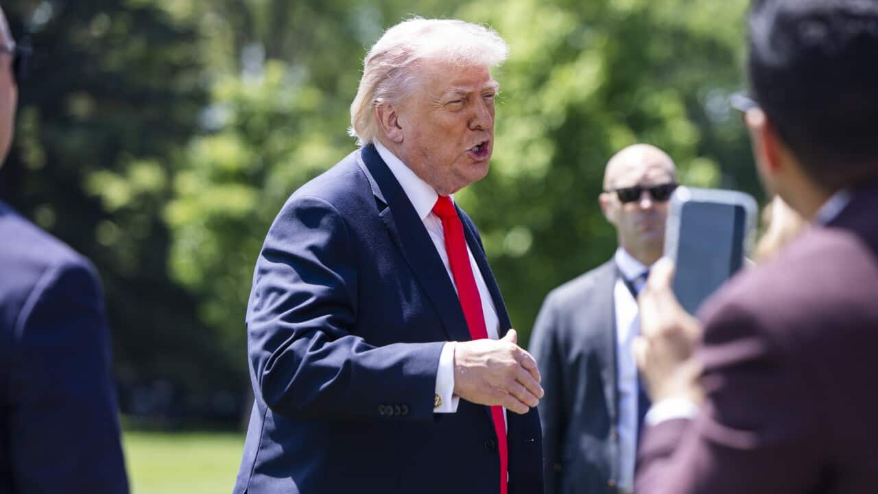 US President Trump speaks to media on the White House lawn.