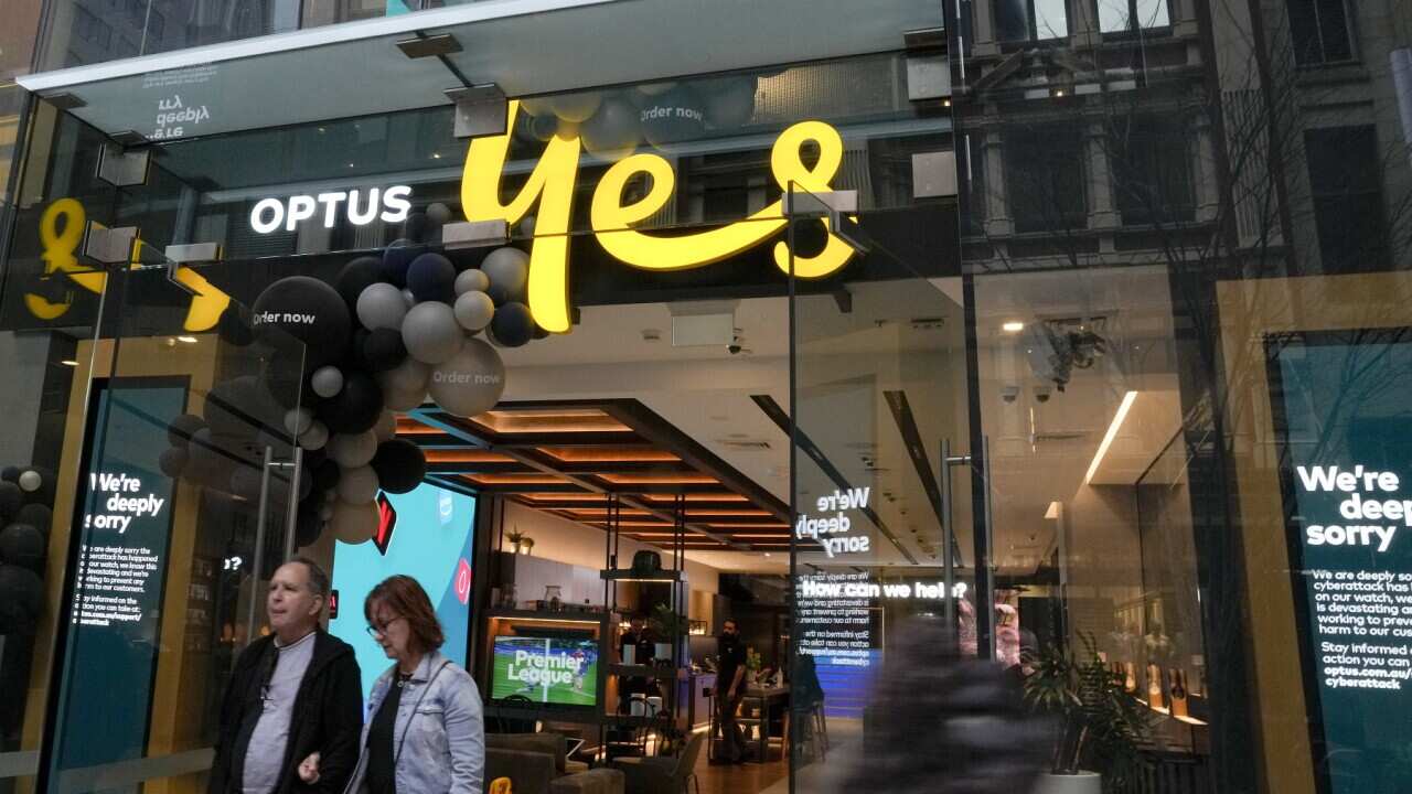 Customers walk out of an Optus telecommunications retail store in Sydney