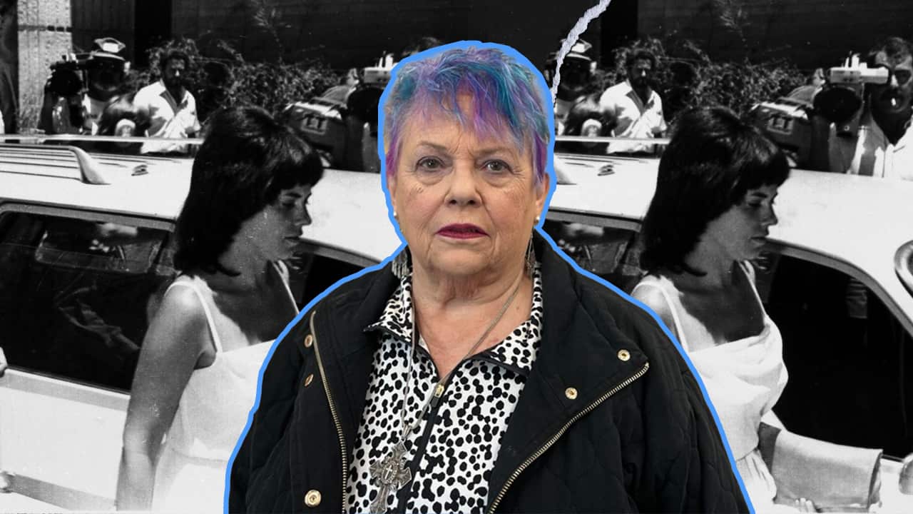 an older woman with blue hair in foreground and a black and white photo of Lindy in front of the car in the background.