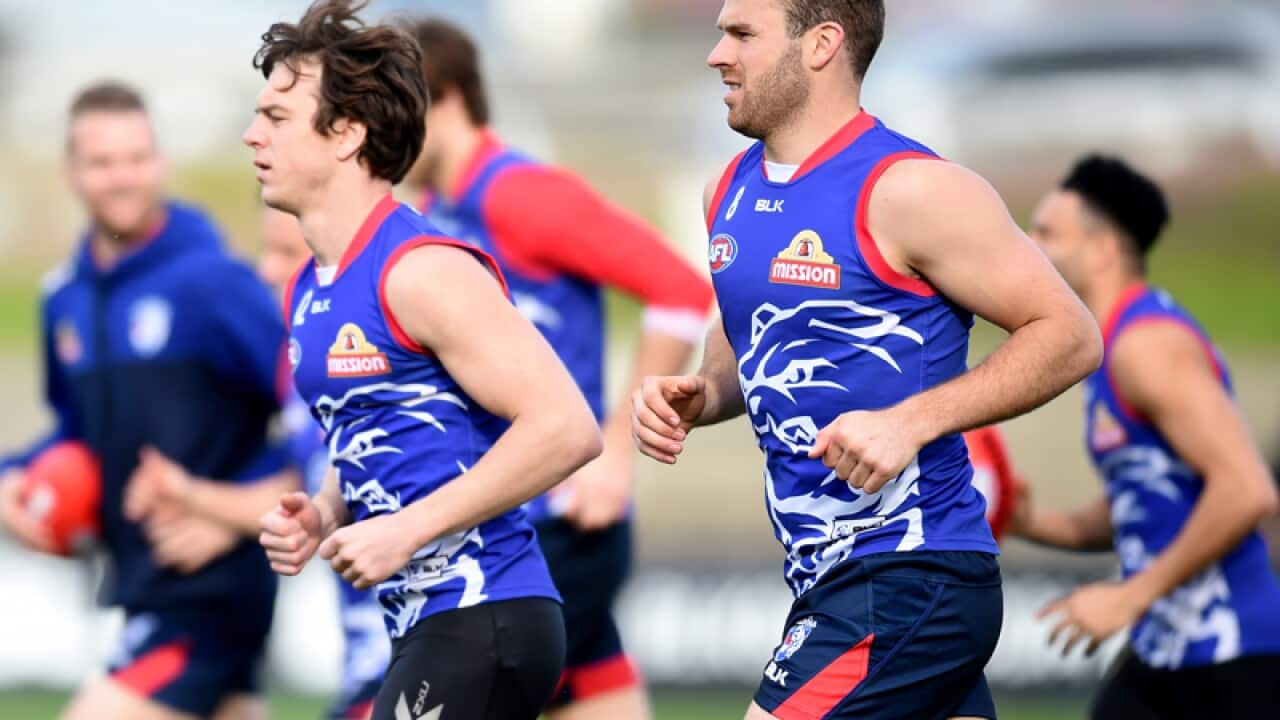 Liam Picken (L) and Stewart Crameri of the Western Bulldogs warm up