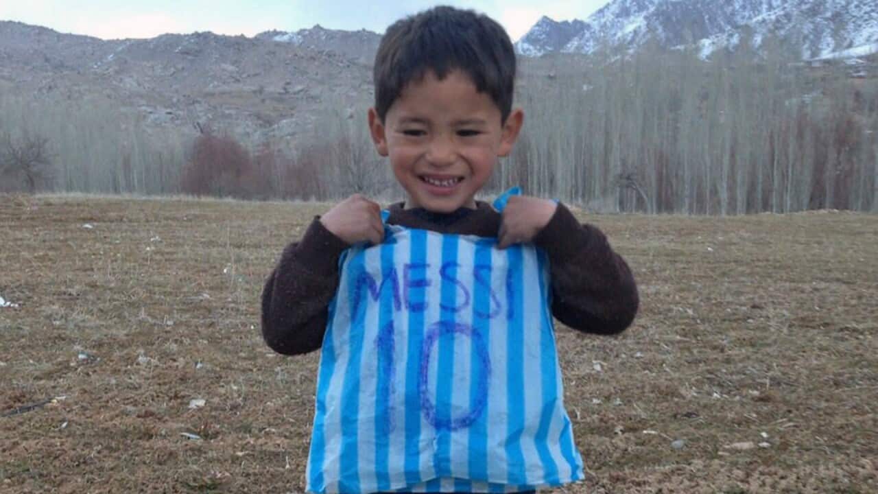 Ahmadi with his homemade plastic bag Messi jersey.