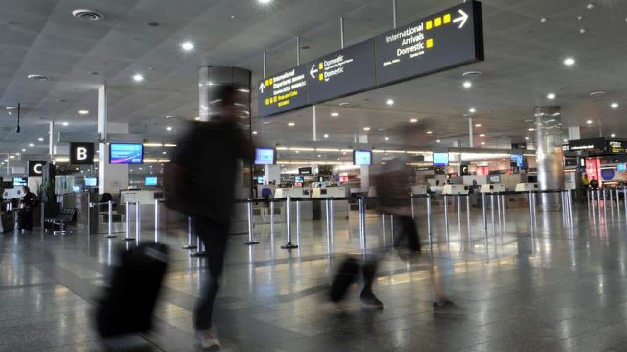 Airline passengers make their way through Melbourne Airport