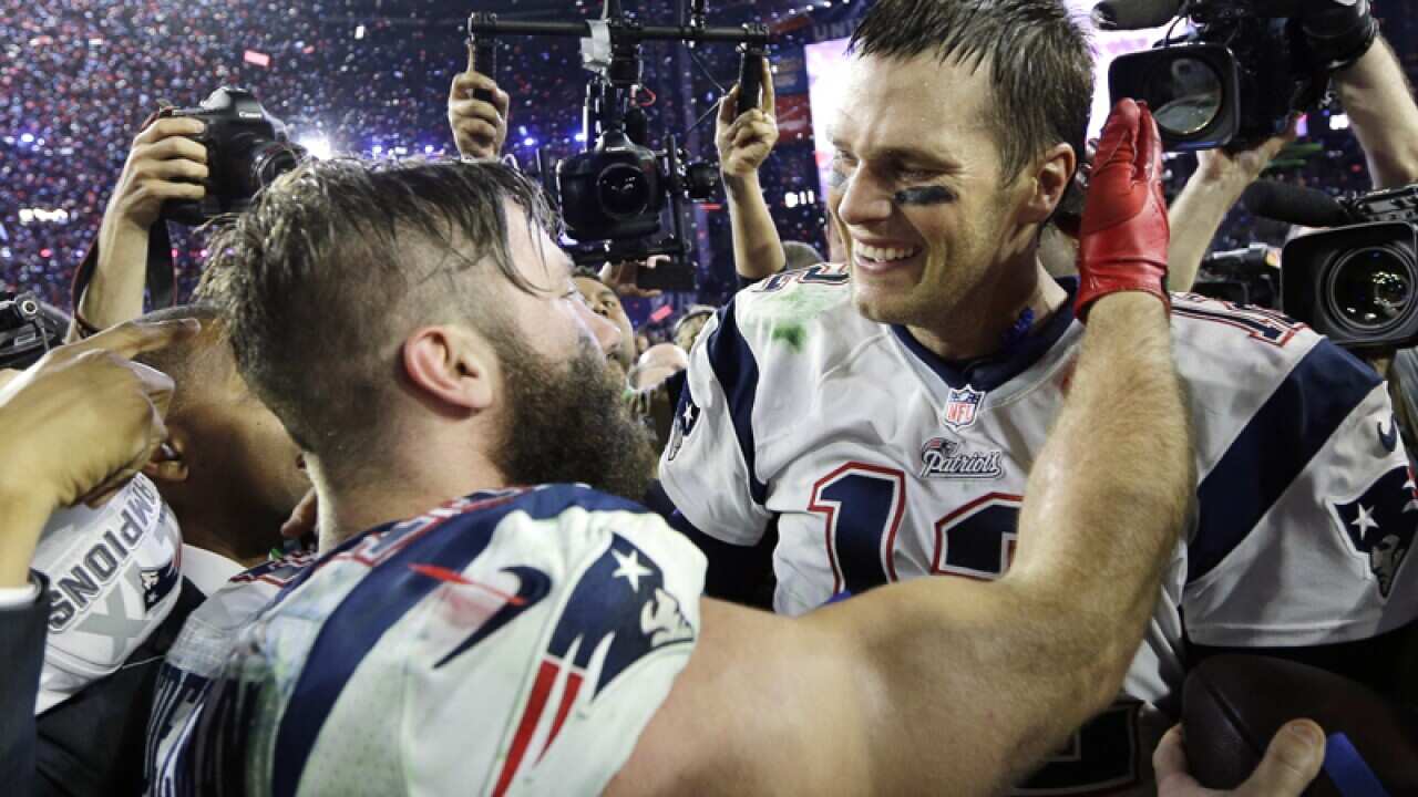 New England quarterback Tom Brady (R) celebrates with Julian Edelman