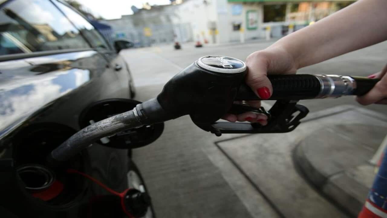 car being filled up with a pump at a petrol station