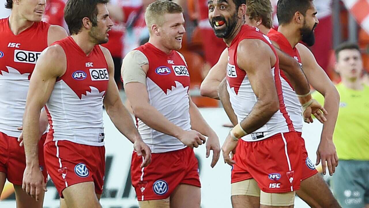Adam Goodes of the Swans as they run away from the Giants