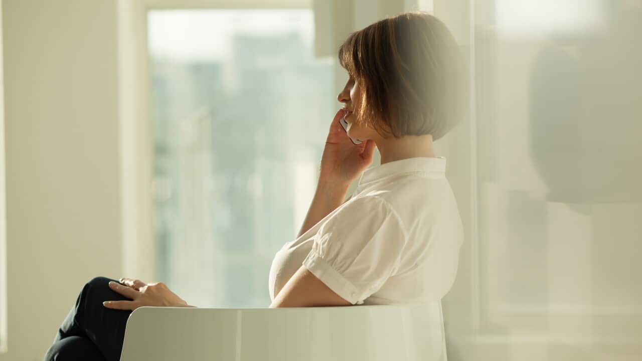 Side view of businesswoman talking on phone