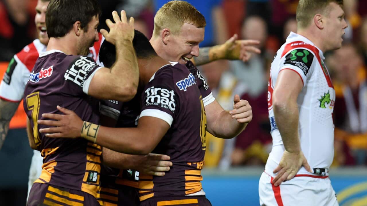 Brisbane Broncos players celebrate.