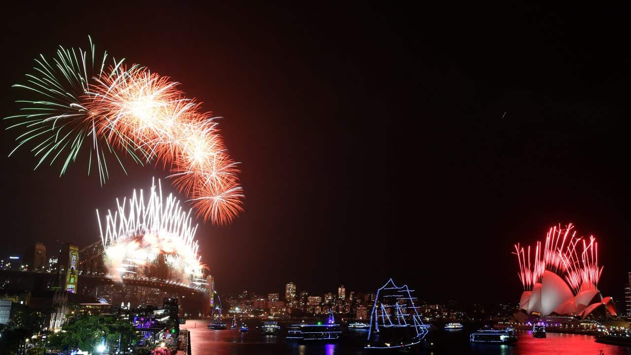 Fireworks explode to welcome in the New Year over the Sydney Harbour Bridge and the Sydney Opera House.
