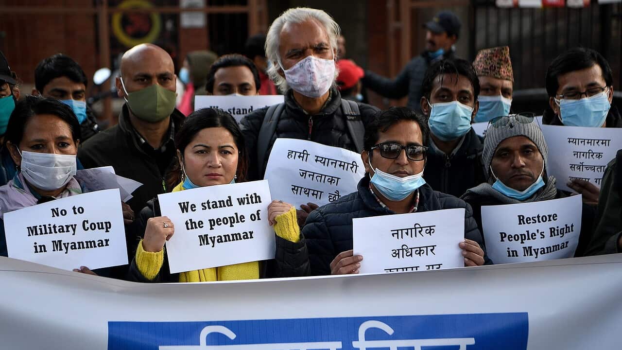 Nepal protesters from the civil society hold placards during a protest in Kathmandu on February 1, 2021, after Myanmar's military seized power