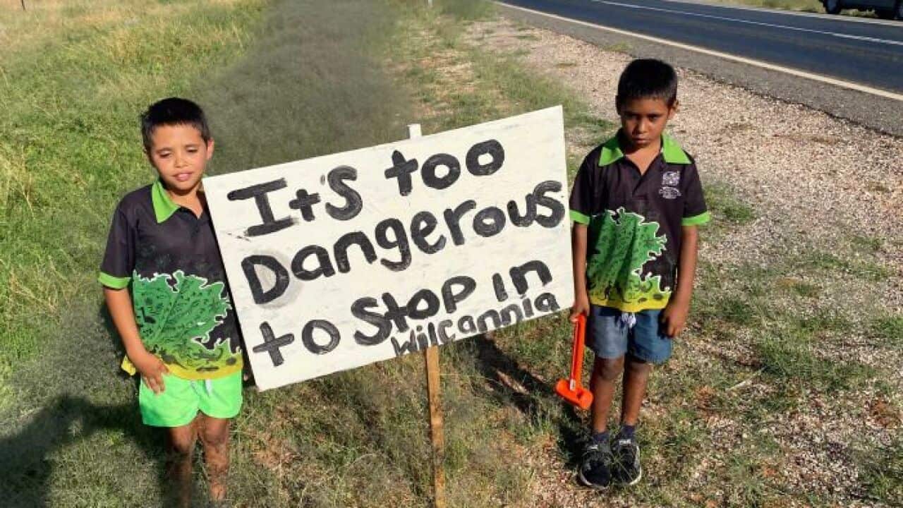 Kids in Wilcannia with placards by roadside to deter visitors from stopping in Wilcannia