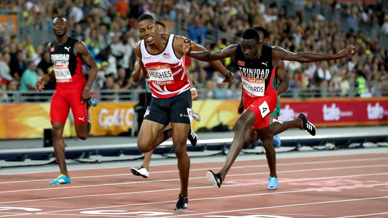 Trinidad and Tobago's Jereem Richards (right) wins the Men's 200m Final after England's Zharnel Hughes is disqualified at the Carrara Stadium