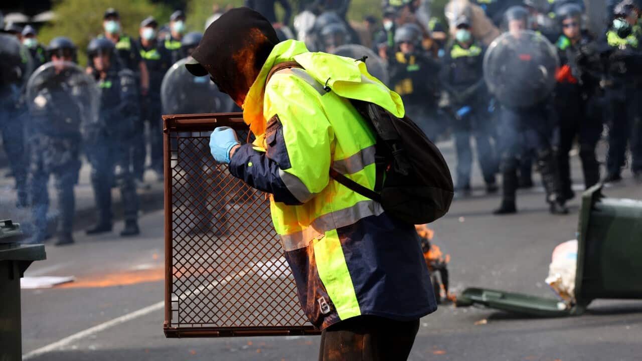 A protester with dye is seen during a protest against the LandForces International Land Defence Exposition at the Melbourne Convention and Entertainment Centre in Melbourne, Wednesday, September 11, 2024.