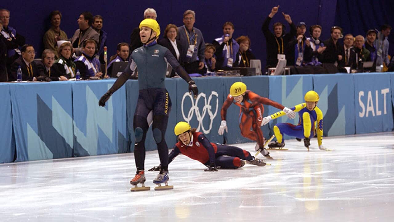 Australia's first ever Winter Gold medal winner Steven Bradbury crosses the line while America's Apolo Anton Ohno scrambles for the line to claim second place after the men's 1000m speed skating final during the Salt Lake City Winter Olympic Games