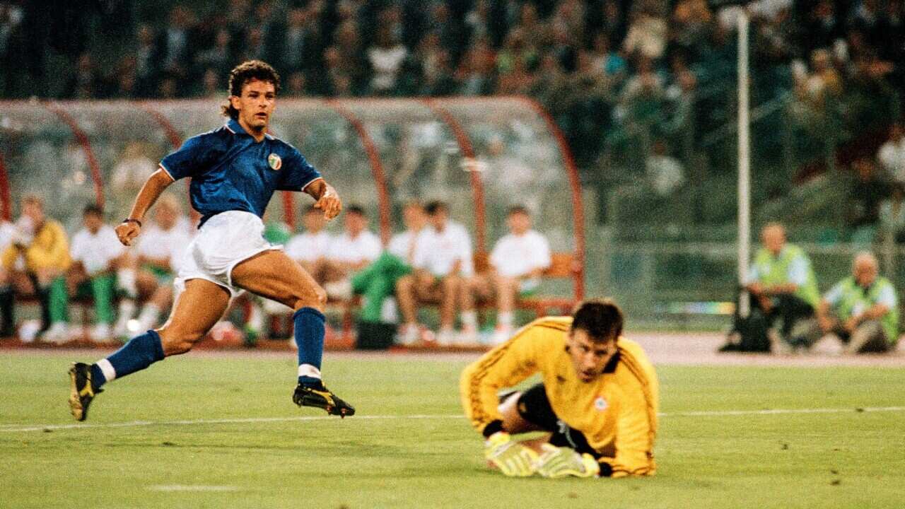Roberto Baggio of Italy scores a goal past Republic of Ireland goalkeeper Packie Bonner only for the goal to be disallowed.