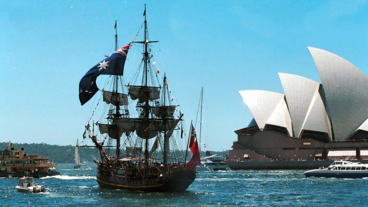 A replica of the famous sailing ship "The Bounty" sails past the Sydney Opera House in Australia.