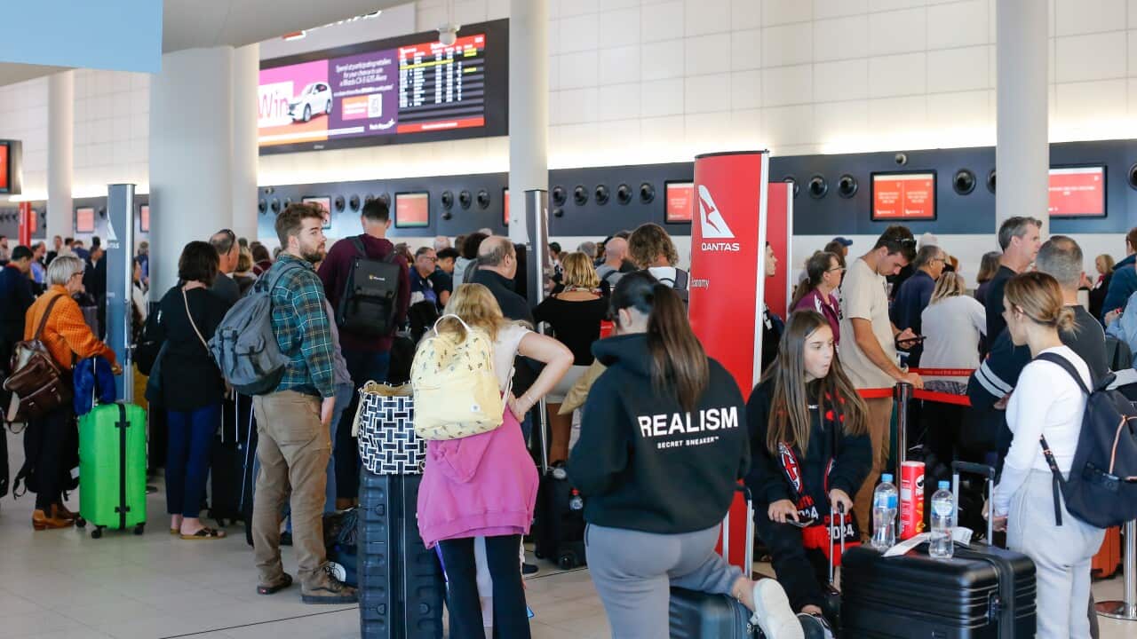 People queued up at an airport.