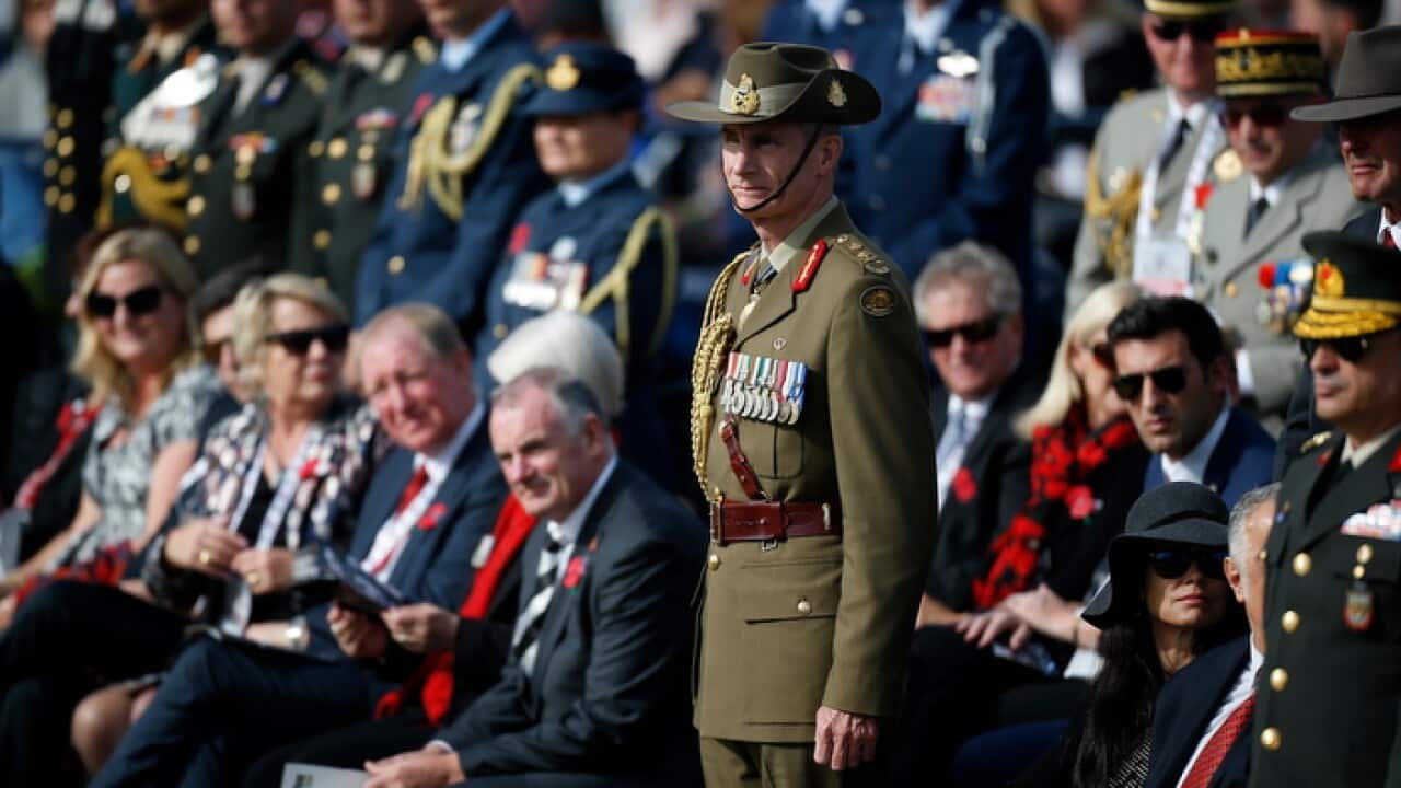 Australia's Defence Force Chief Gen. Angus Campbell stands to attention at the Lone Pine Cemetery, in Gallipoli peninsula
