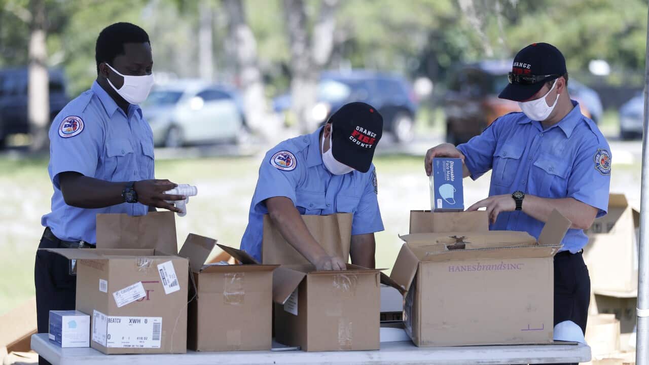 Members of Orange County Fire Rescue in California pack personal protective equipment (PPE) items to be handed out to small businesses.