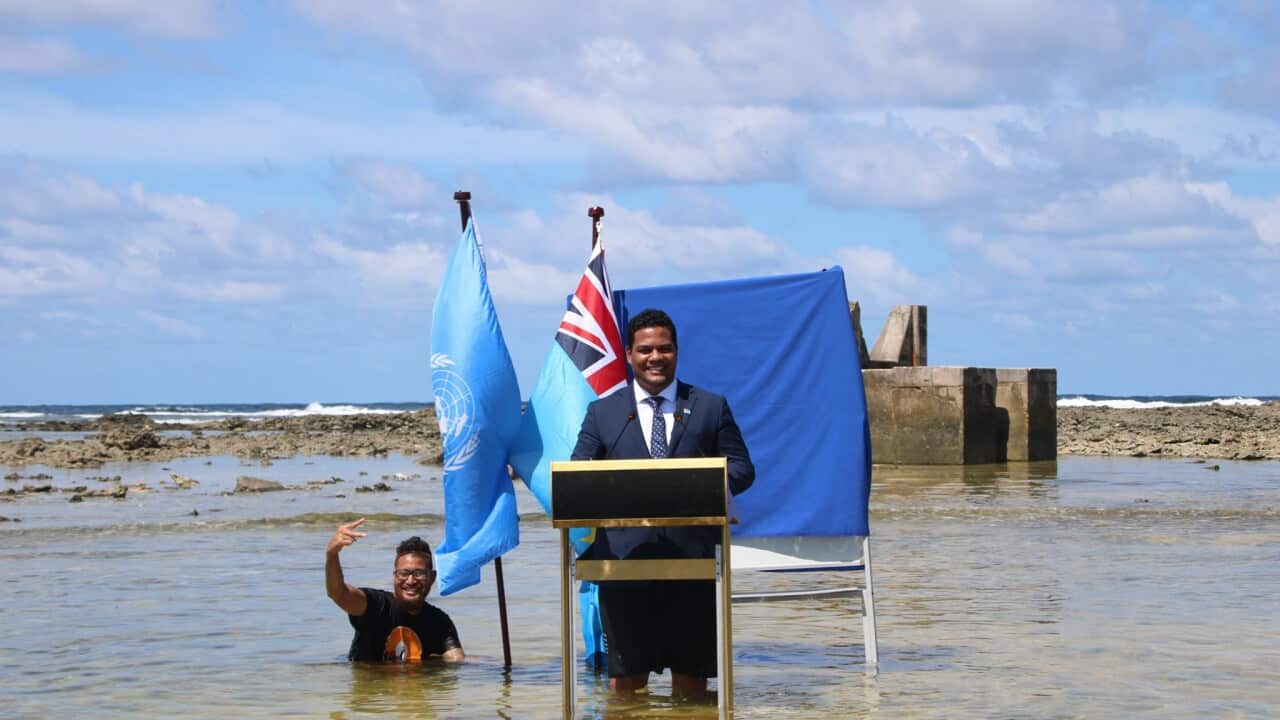 Tuvalu leader Simon Kofe films his COP26 address knee deep in water.