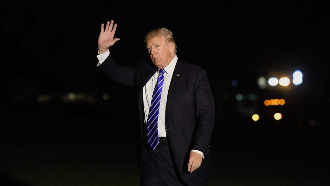 US President Donald J. Trump waves as he walks on the South Lawn after he returns to the White House in Washington, DC, USA. EPA/OLIVIER DOULIERY / POOL